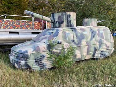 Another minivan, this one modified into a camo war wagon.