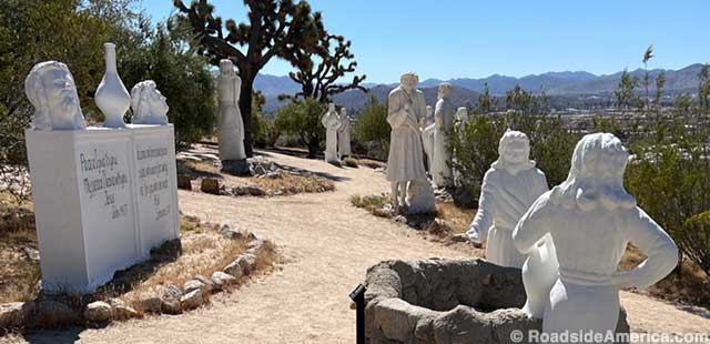 Heads-on-a-wall and biblical figures overlook Yucca Valley at Desert Christ Park.
